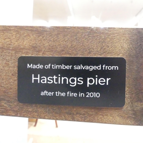 2025 - HASTINGS PIER INTEREST - A stained teak plank-top dining table, constructed from timber salvaged fro... 