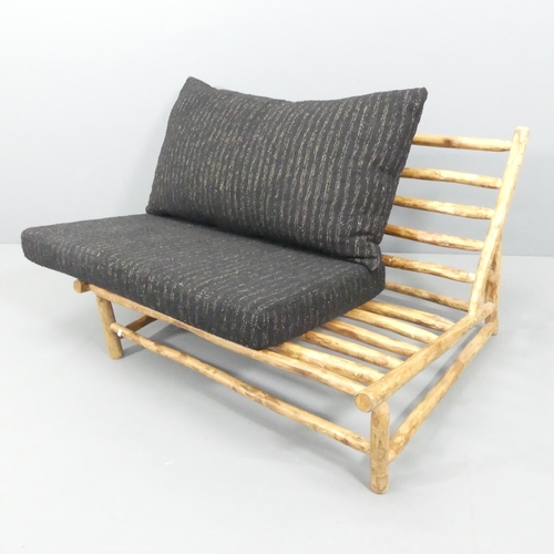 2033 - A two-seater mid-century style Brutalist settee by Rock the Kasbah, with maker's label.