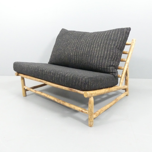 2033 - A two-seater mid-century style Brutalist settee by Rock the Kasbah, with maker's label.