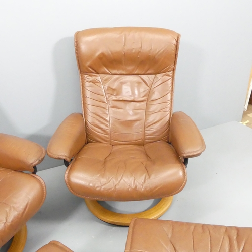 2042 - EKORNES - A pair of vintage brown leather upholstered stressless reclining swivel lounge chairs, wit... 