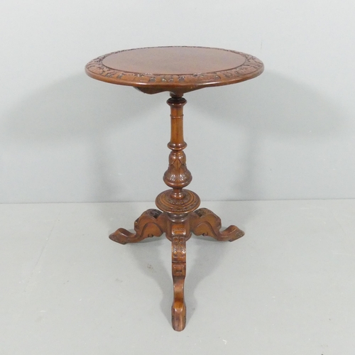 2113 - An antique mahogany circular topped occasional table, with carved decoration, turned central column ... 