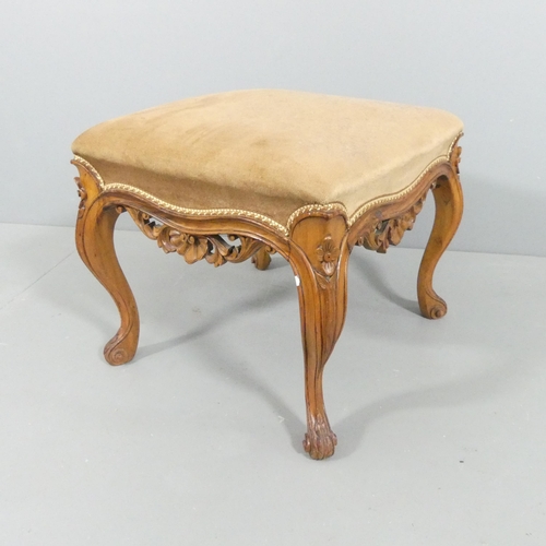 2116 - A continental walnut and upholstered footstool, with carved decoration and raised on cabriole legs. ... 