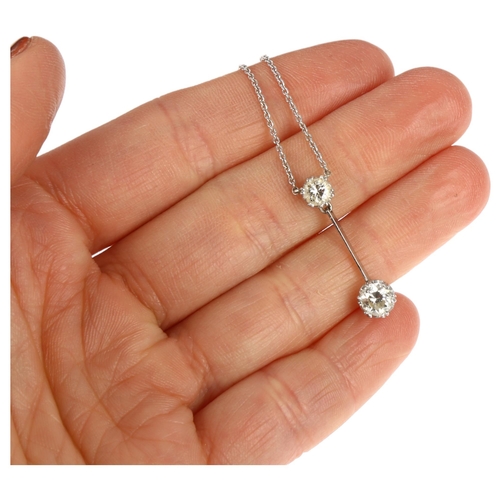 1107 - An 18ct white gold two stone diamond drop pendant necklace, claw set with modern round brilliant-cut... 