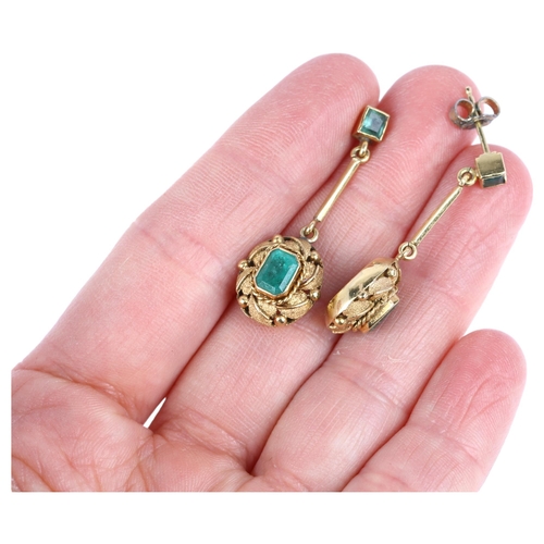 1109 - A pair of late 20th century emerald drop earrings, rub-over set with octagonal and square step-cut e... 