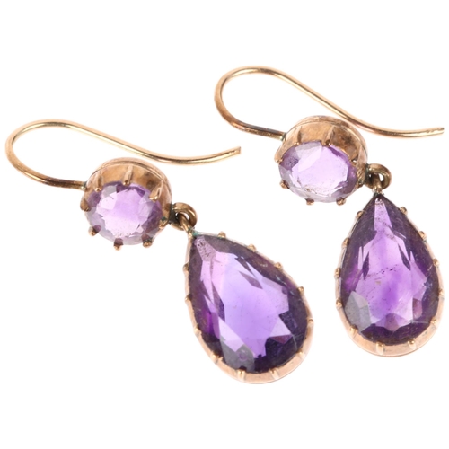 1136 - A pair of Edwardian amethyst drop earrings, cut-down collet settings with pear and round-cut amethys... 