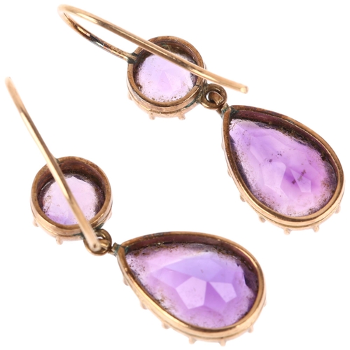 1136 - A pair of Edwardian amethyst drop earrings, cut-down collet settings with pear and round-cut amethys... 