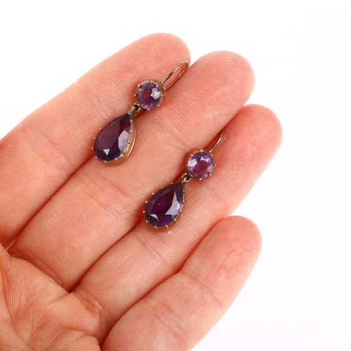 1136 - A pair of Edwardian amethyst drop earrings, cut-down collet settings with pear and round-cut amethys... 