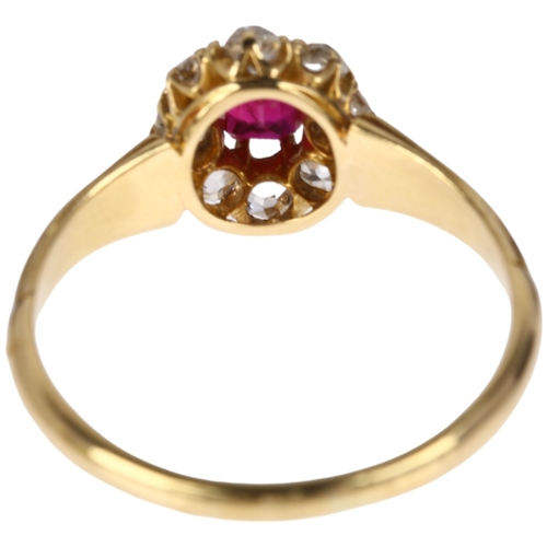 1141 - An early/mid 20th century ruby and diamond oval cluster ring, claw set with 0.35ct oval mixed-cut ru... 