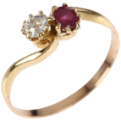 1142 - An early 20th century two stone ruby and diamond crossover ring, claw set with round-cut ruby and 0.... 