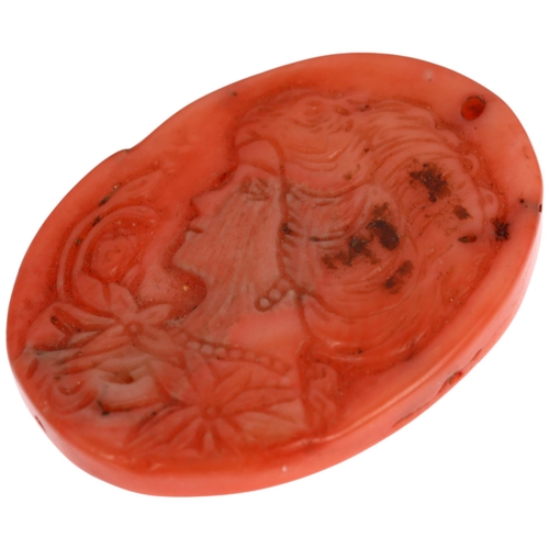 1151 - An Art Nouveau coral cameo panel pendant, relief carved depicting female profile with flowers, 35.0 ... 