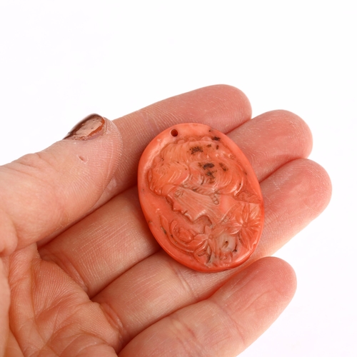 1151 - An Art Nouveau coral cameo panel pendant, relief carved depicting female profile with flowers, 35.0 ... 