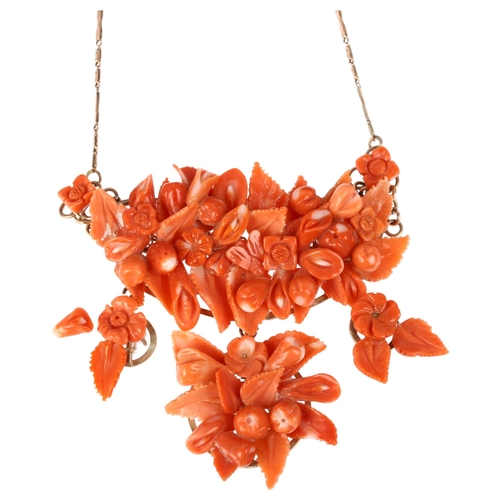 1152 - An Italian 14ct rose gold coral floral collar necklace, set with relief carved leaf flowerhead and f... 