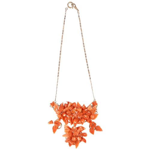 1152 - An Italian 14ct rose gold coral floral collar necklace, set with relief carved leaf flowerhead and f... 