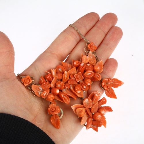 1152 - An Italian 14ct rose gold coral floral collar necklace, set with relief carved leaf flowerhead and f... 