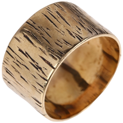 1166 - A late 20th century 9ct gold wedding band ring, maker PMH, London 1981, engraved naturalistic bark d... 