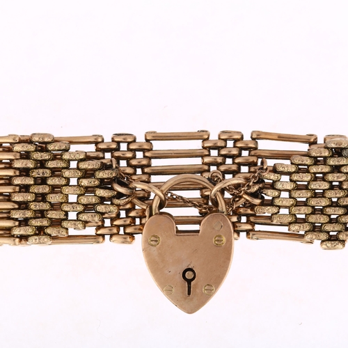 1182 - An early/mid 20th century 9ct gold gatelink bracelet, with 9ct heart padlock clasp, maker AM, 19cm, ... 