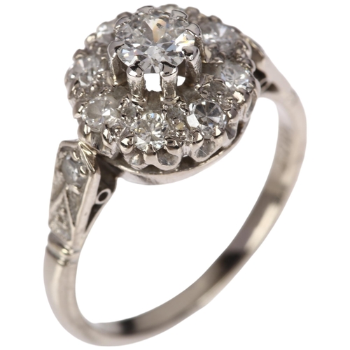 1185 - An 18ct white gold diamond flowerhead cluster ring, claw set with round-cut diamonds, total diamond ... 