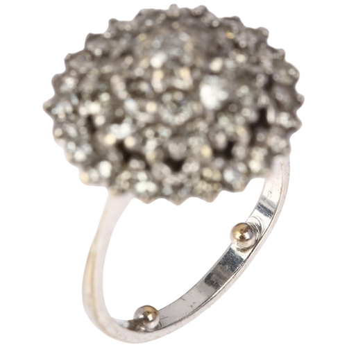 1186 - An 18ct white gold diamond circular cluster ring, stepped form, claw set with modern round brilliant... 