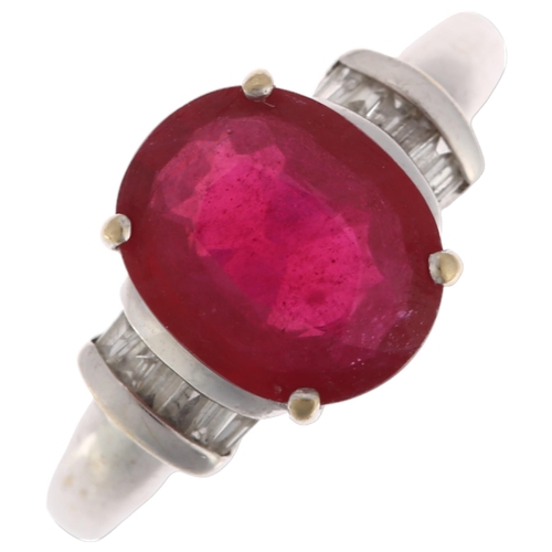 1189 - A modern 18ct white gold ruby and diamond dress ring, claw set with 2.7ct oval mixed-cut ruby flanke... 