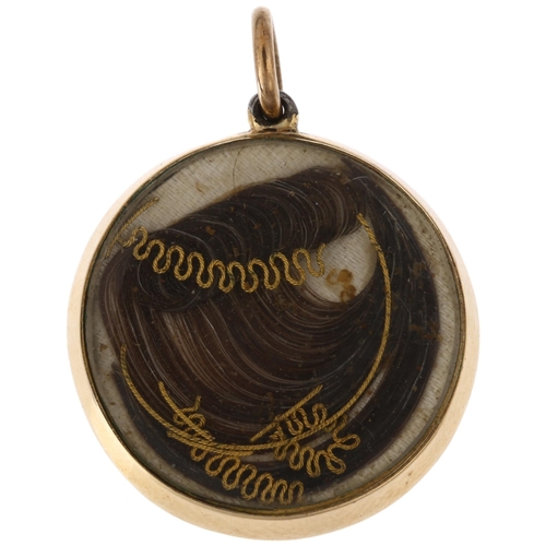 1192 - A Georgian black enamel and split pearl 'forget-me-not' mourning locket pendant, with scrolled hairw... 