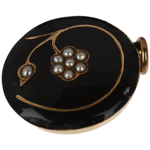 1192 - A Georgian black enamel and split pearl 'forget-me-not' mourning locket pendant, with scrolled hairw... 