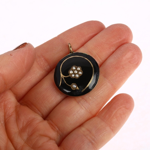 1192 - A Georgian black enamel and split pearl 'forget-me-not' mourning locket pendant, with scrolled hairw... 