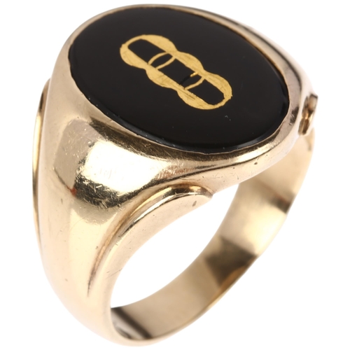 1196 - A large American 9ct gold black onyx Oddfellows signet ring, intaglio carved and gilt with insignia,... 