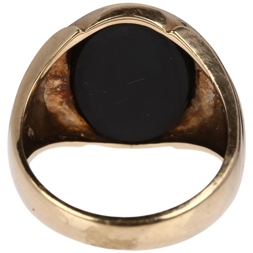 1196 - A large American 9ct gold black onyx Oddfellows signet ring, intaglio carved and gilt with insignia,... 