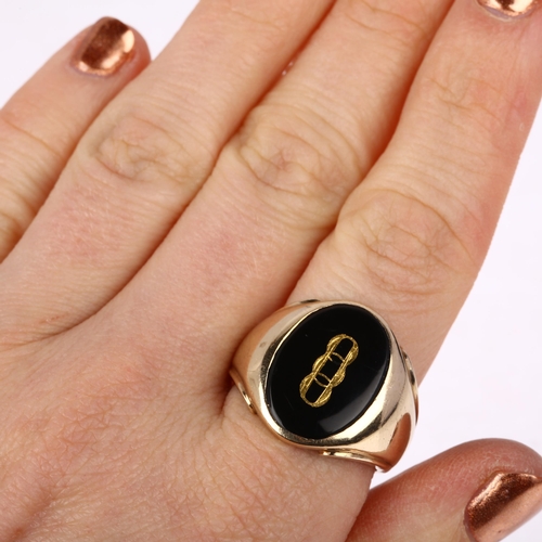 1196 - A large American 9ct gold black onyx Oddfellows signet ring, intaglio carved and gilt with insignia,... 