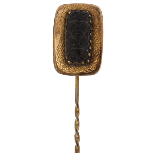 1206 - A Georgian jet stickpin, relief carved decoration, in unmarked yellow metal settings, head 19.8mm, o... 