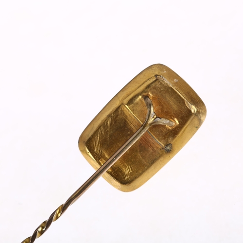 1206 - A Georgian jet stickpin, relief carved decoration, in unmarked yellow metal settings, head 19.8mm, o... 