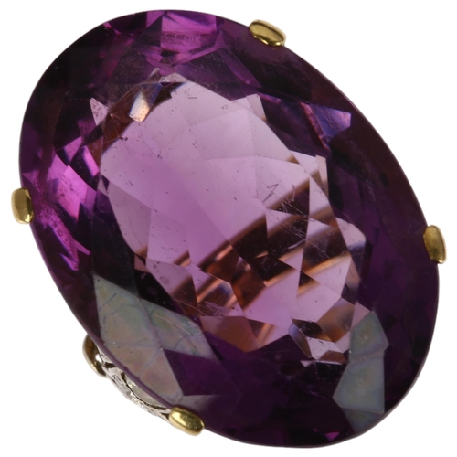 1227 - A large 18ct gold amethyst and diamond cocktail ring, claw set with 40ct oval mixed-cut amethyst, se... 