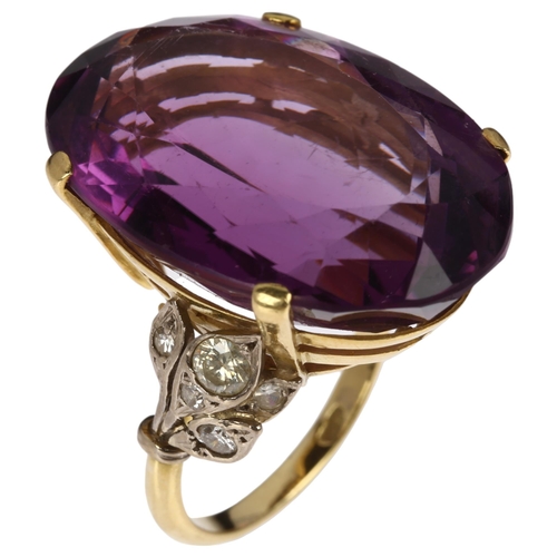 1227 - A large 18ct gold amethyst and diamond cocktail ring, claw set with 40ct oval mixed-cut amethyst, se... 