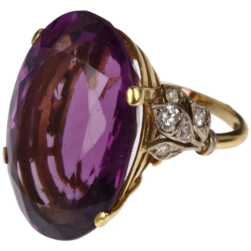 1227 - A large 18ct gold amethyst and diamond cocktail ring, claw set with 40ct oval mixed-cut amethyst, se... 