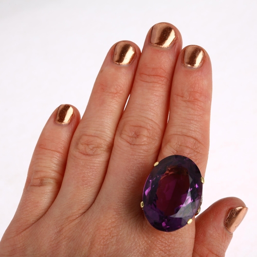 1227 - A large 18ct gold amethyst and diamond cocktail ring, claw set with 40ct oval mixed-cut amethyst, se... 