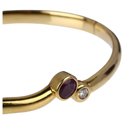 1230 - An Italian 18ct gold two stone ruby and diamond hinged bangle, maker B&C Gioielli within wings, rub-... 