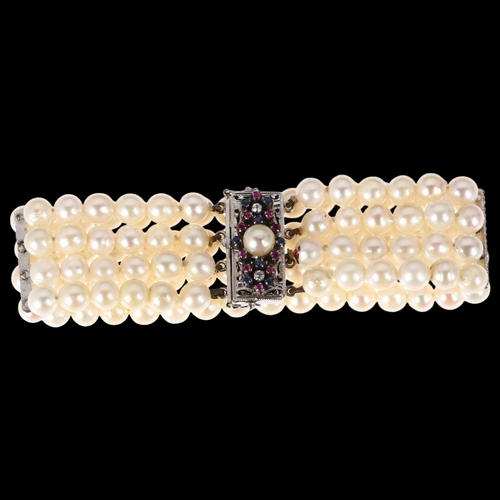 1243 - A quadruple strand pearl bead bracelet, with 18ct white gold pearl ruby sapphire and diamond clasp a... 