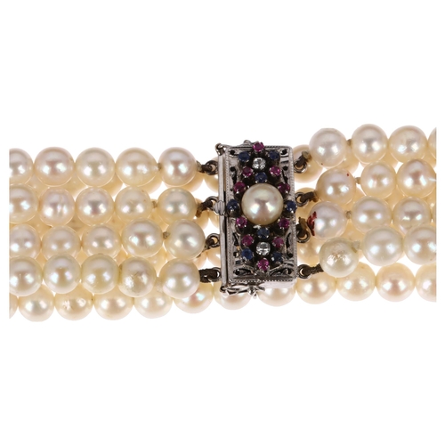 1243 - A quadruple strand pearl bead bracelet, with 18ct white gold pearl ruby sapphire and diamond clasp a... 