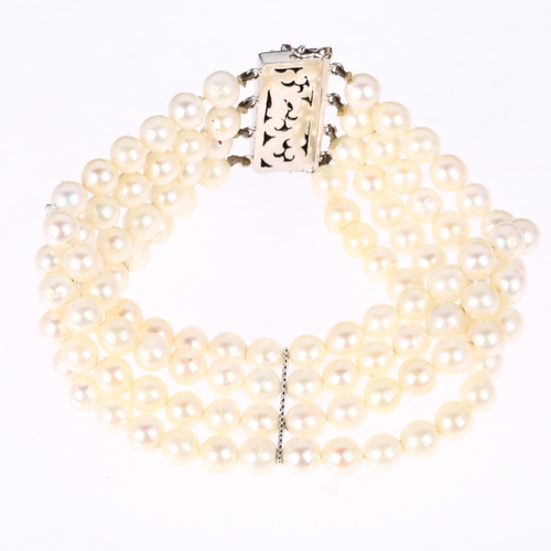 1243 - A quadruple strand pearl bead bracelet, with 18ct white gold pearl ruby sapphire and diamond clasp a... 