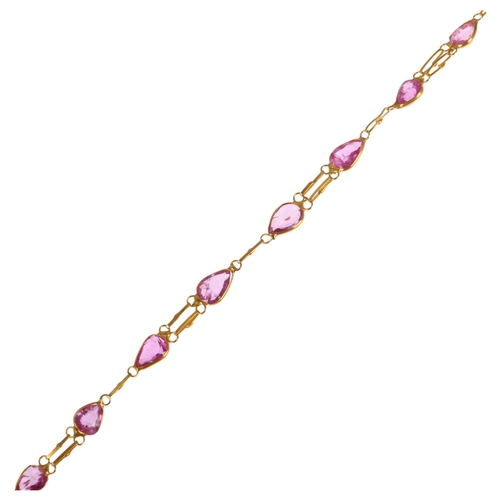 1274 - A 14ct gold pink sapphire tennis line bracelet, rub-over set with pear-cut sapphires, 16cm, 1.7g