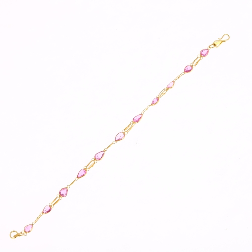 1274 - A 14ct gold pink sapphire tennis line bracelet, rub-over set with pear-cut sapphires, 16cm, 1.7g