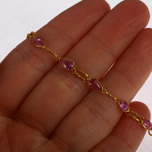 1274 - A 14ct gold pink sapphire tennis line bracelet, rub-over set with pear-cut sapphires, 16cm, 1.7g