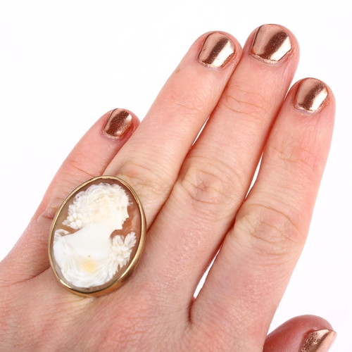 1280 - A large mid-20th century shell cameo ring, relief carved depicting Art Nouveau female profile, appar... 