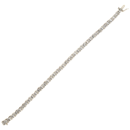 1292 - A modern 9ct gold diamond line bracelet, maker JR, claw set with modern round brilliant-cut diamonds... 