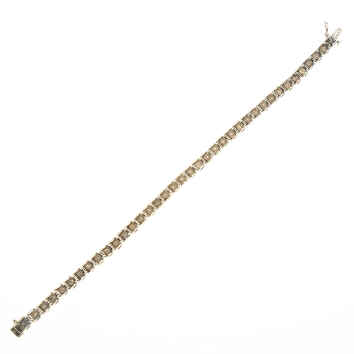 1292 - A modern 9ct gold diamond line bracelet, maker JR, claw set with modern round brilliant-cut diamonds... 