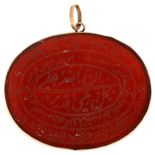 1294 - An Islamic carnelian Arabic talisman amulet pendant, unmarked yellow metal frame, width 37mm, 5g