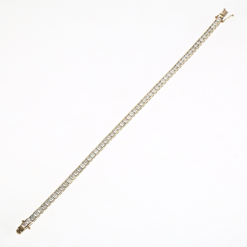 1312 - A modern 9ct gold cubic zirconia tennis line bracelet, 19cm, 9.8g