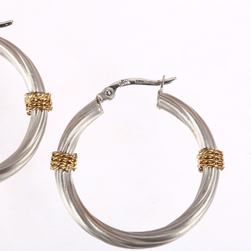 1347 - A pair of 9ct two-colour gold hoop earrings, maker BX, London 2002, twisted design with applied wire... 