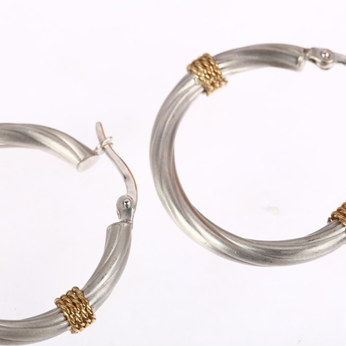 1347 - A pair of 9ct two-colour gold hoop earrings, maker BX, London 2002, twisted design with applied wire... 