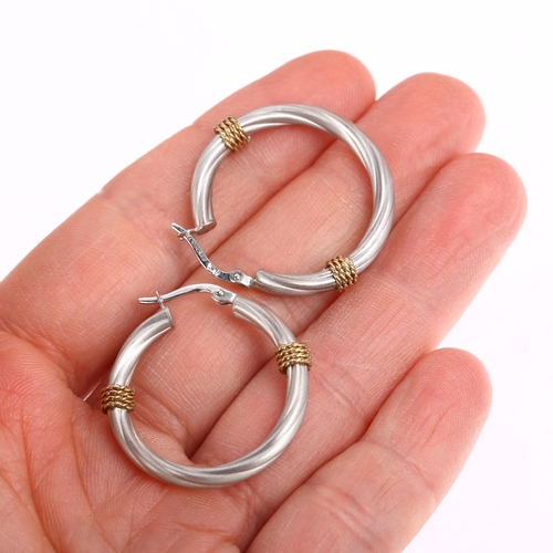 1347 - A pair of 9ct two-colour gold hoop earrings, maker BX, London 2002, twisted design with applied wire... 